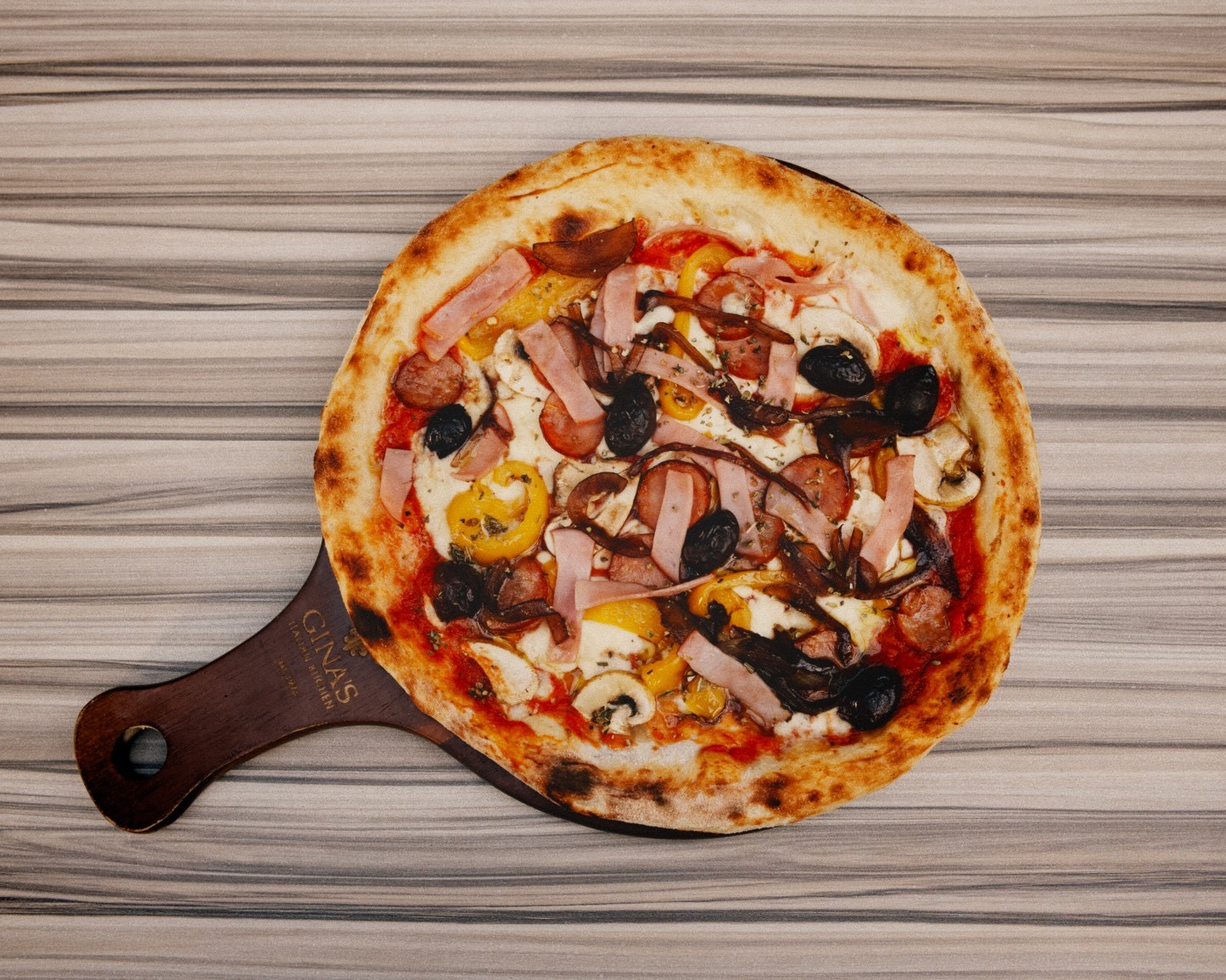 Capricciosa pizza on a Gina's board